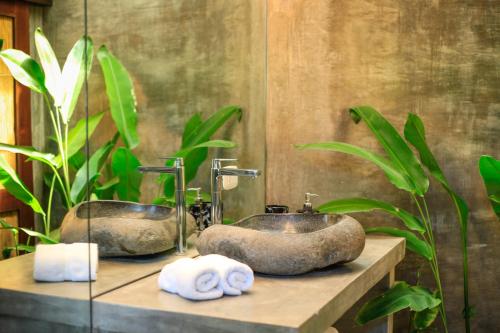 a bathroom with two sinks and towels on a counter at Lua Villas in Santa Teresa Beach