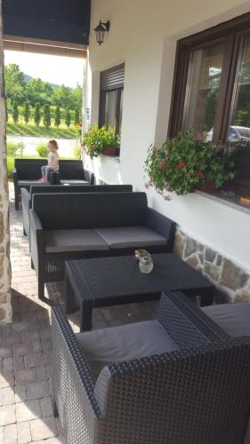a row of tables and chairs on a patio at Villa Stone in Rakovica