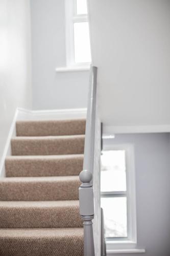 a stairway with stairs in a house at Keld Green House in Seascale