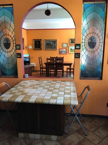 a room with a table and stained glass windows at Rainbow Relais in Lesa