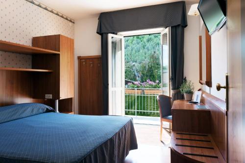 a bedroom with a blue bed and a window at Casa Ferretti di Ferretti Village in Silvi Marina