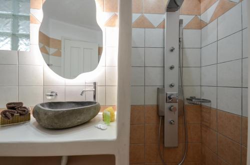 a bathroom with a stone sink and a shower at Naxos Dream Oniro Studios - Adults Only in Naxos Chora