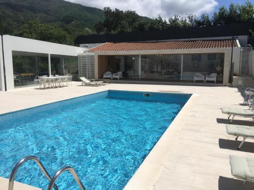 a swimming pool with a patio and a house at Villa vicino Napoli in Pollena Trocchia