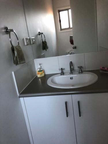 a bathroom with a sink and a mirror at Cowes Holiday Haven - Property 1 in Cowes
