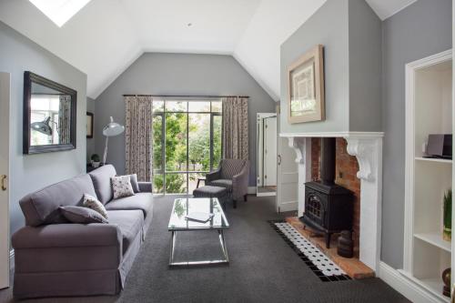 a living room with a couch and a fireplace at Oak Tree Lodge in Rhyll
