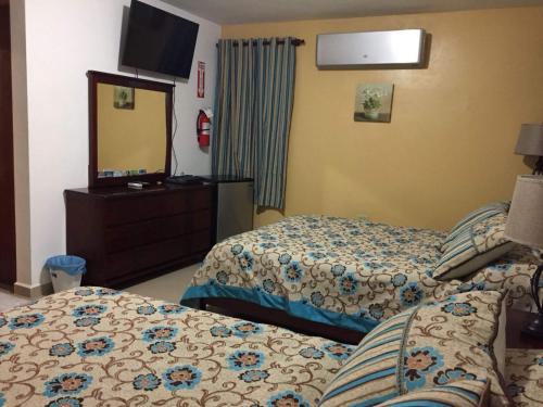 a hotel room with two beds and a mirror at Country Family in Culebra