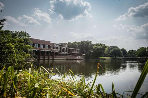 a building sitting next to a body of water at Hyatt Lodge Oak Brook Chicago in Oak Brook