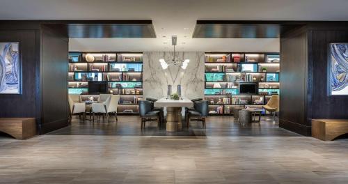 a dining room with a table and chairs and book shelves at Hyatt Centric Chicago Magnificent Mile in Chicago