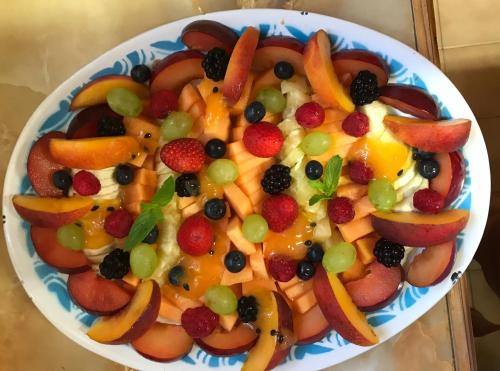 a bowl filled with fruits and vegetables on a table at Kromrivier Farm Stays & B&B Near Addo Elephant Park in Paterson