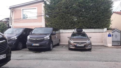a group of cars parked in a parking lot at Aloha Apartments with pool in Skopje