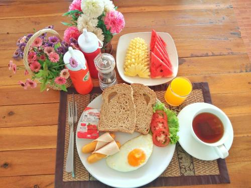 a breakfast plate of eggs and bread and a cup of coffee at Lanta Lapaya Resort in Ko Lanta