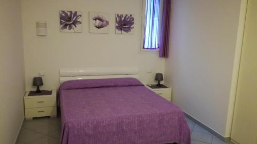 a bedroom with a purple bed and two night stands at Casa Margherita in Lerici