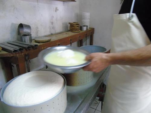 a person using a spoon to stir up some food at To Exari in Omalos