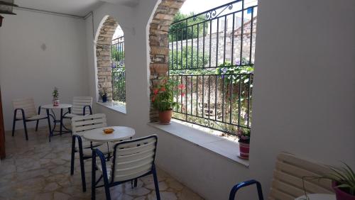 a room with two tables and chairs and two windows at Kallirroi Studios in Pythagoreio