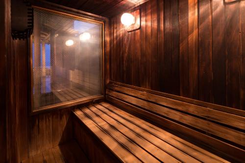 an empty wooden sauna with a window in it at Bousui in Higashiizu