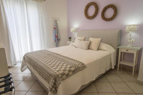 a bedroom with a bed and a mirror on the wall at Hotel Cyclades in Parikia