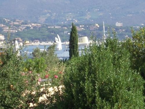 a view of a harbor with a white statue in the distance at Résidence Saint Tropez in Saint-Tropez