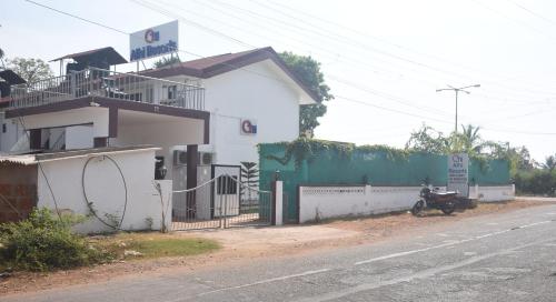 a house with a motorcycle parked next to a street at Athi Resorts in Bogmolo