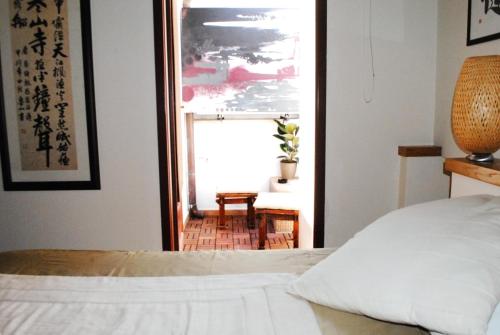 a bedroom with a bed and a large window at BeMyGuest Rutigliano in Rutigliano