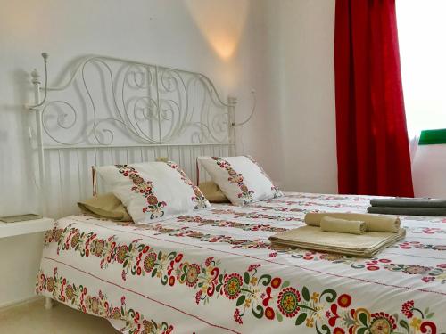 a bedroom with a bed with a red curtain at Apartamentos Flamboyant Adults Only in Puerto del Carmen