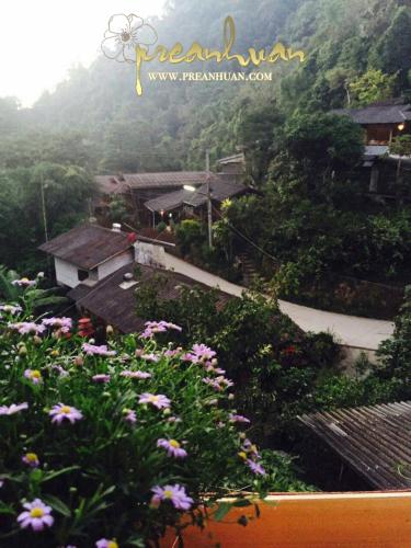 a view of a village with flowers in the foreground at Preanhuan Homestay in Mae On