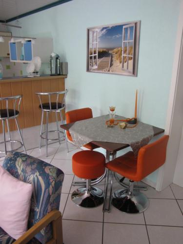 a kitchen with a table and chairs in a room at Gästezimmer in Aspach in Aspach