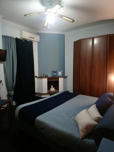 a bedroom with a bed and a ceiling fan at Villa Axa in Casal Palocco