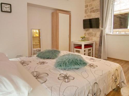 a bedroom with a bed with two pillows on it at Luna in Dubrovnik