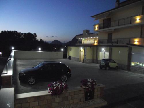 a car parked in a parking lot next to a building at Il Girasole in Terracina