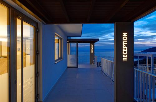 a balcony of a building with a view of the ocean at Zlatni Zalaz,Apartments,Supetarska Draga in Supetarska Draga