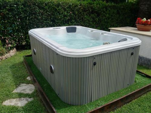 a hot tub sitting on the grass in a yard at Residence Aurora Wellness & Spa in Albenga