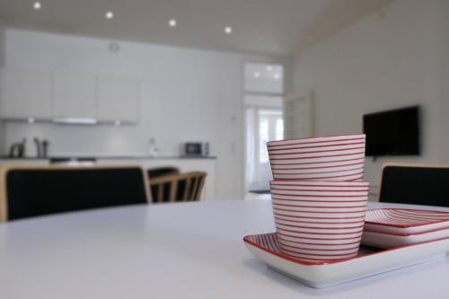 a stack of red and white plates on a table at Dragør Hotel & Apartments in Dragør