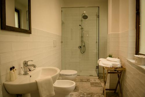a bathroom with a sink and a toilet and a shower at BnB Paolina in Siena