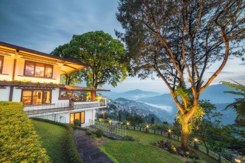 a house with a view of the mountains at Denzong Regency- Luxury Mountain Retreat Spa & Casino in Gangtok