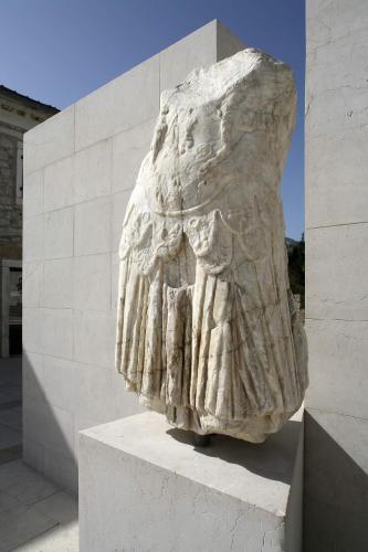 a statue of a woman on a stone wall at Hotel Merlot in Opuzen