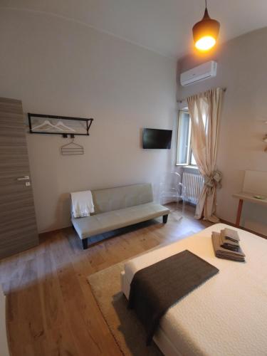 a living room with a bed and a couch at Diadumeno Superior Apartment in Venosa