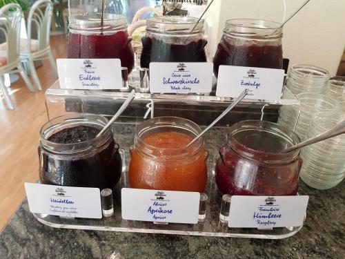 a bunch of jars of jam sitting on a counter at Waldhotel Bad Sulzburg in Sulzburg