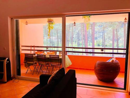 a living room with a couch and a dining room at Sea Breeze Golf & Beach Villa in Charneca