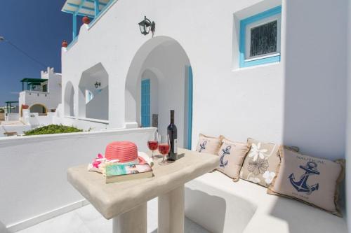 a table with a glass of wine on a balcony at Keti Kapri in Plaka