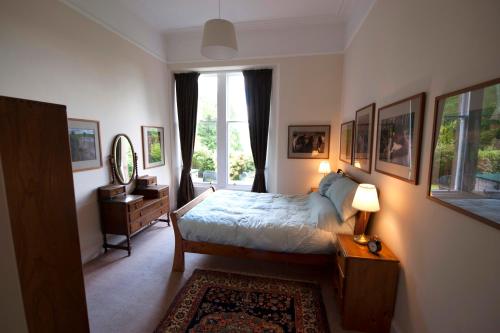 a bedroom with a bed and a window at Warriston Apartment at Holm Park in Moffat