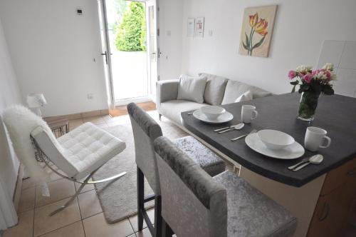 uma cozinha e sala de estar com mesa e cadeiras em Stable Cottage, Whitebridge Farm em Shaftesbury