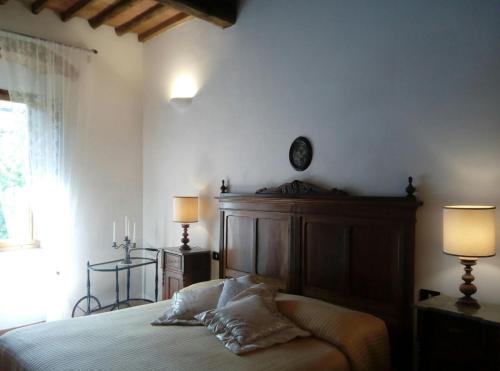 a bedroom with a bed with two pillows on it at Torre rossa in Bolgheri