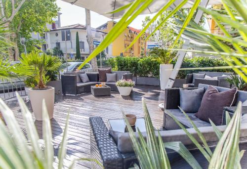 une terrasse avec des canapés et des plantes dans l'établissement Residence Millennium, à Rimini