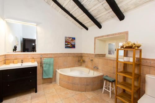 a bathroom with a tub and a sink and a mirror at Varanski Vista in San Miguel de Abona