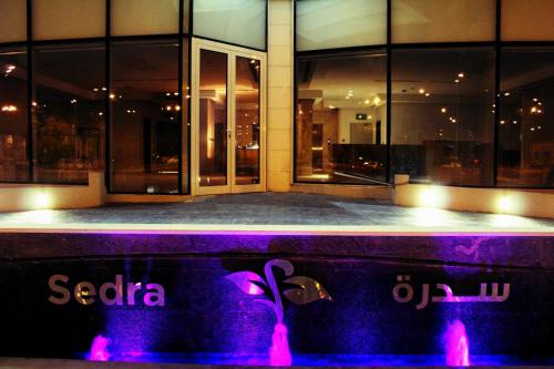 a building at night with purple lights in front at Sedra Residence in Kuwait