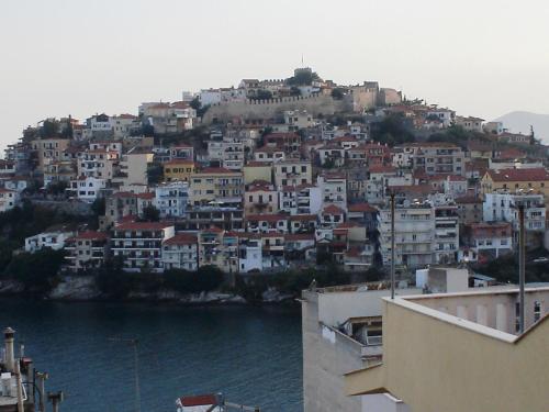 a group of houses on a hill next to the water at Traditional House Paschalis in Kavala
