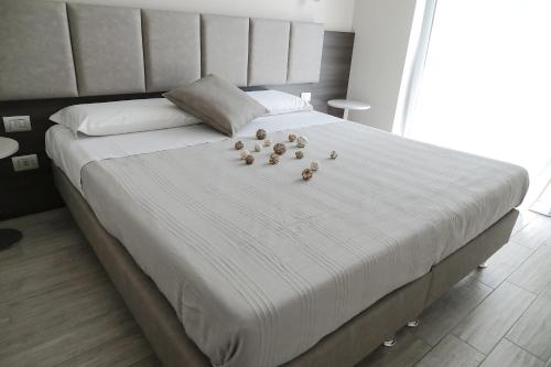 a white bed with a bunch of ducks on it at Residenza Angelica in Lazise