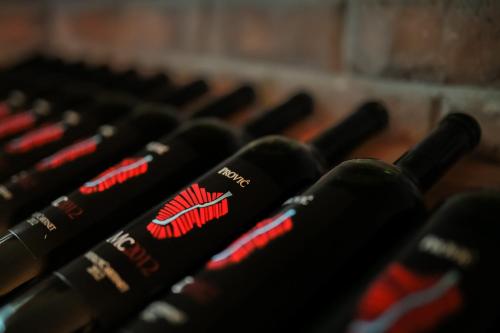 a row of black bottles of wine sitting next to each other at Hotel Merlot in Opuzen