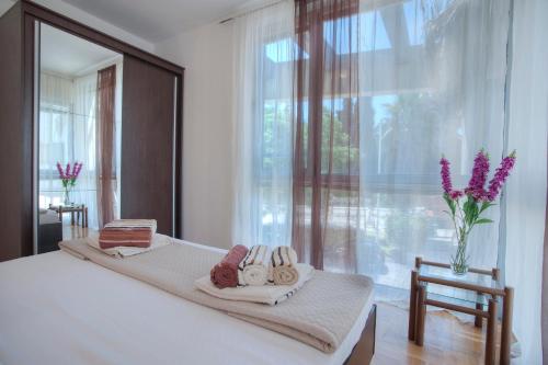 a bedroom with a bed with a large window at Dobrljanin LUX apartment in Budva