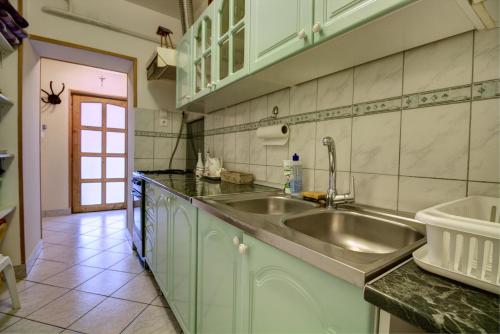 a kitchen with a sink and a counter top at Oázis Apartman in Eger
